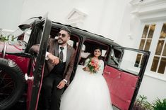 a bride and groom are getting out of an old car