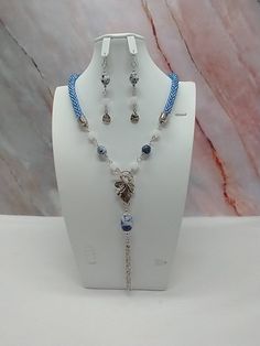 "Handmade and designed by me-one of a kind necklace set-blue seed bead crocheted rope necklace-22\" long-2 1/2\" long chain tassel with a sodalite nugget-sodalite accent beads-matte frosted dragon vein agate cube beads-metsl beads-3 1/4\" long dangle earrings with a flower charm-antique silver tone leaf toggle clasp in front-antique silver tone findings. Make this unique necklace set a great addition to your jewelry collection! Would make a statement when adding to your summer outfit!" Crochet Gemstone, Necklace Matching, Bead Crochet Rope, Dragon Vein Agate, Cube Beads, Crochet Rope, Earrings Pendant, Long Dangle Earrings, Unique Necklace