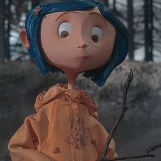 a doll with blue hair is holding a branch