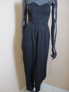 Women's vintage black jumpsuit. Strapless with boned corset side zipand side pockets, elastic section in the back. Lovely jumpsuit for a night out. dimensions: Bust: 28 Inches. Waist: 24 Inches. Length: 46 Inches. Width of ankle: 12 Inches. Made in France Corset Jumpsuit, Vintage Playsuit, Jumpsuit Vintage, Womens Jumpsuits, Black Jumpsuit, Playsuit, Evening Wear, Jumpsuits For Women, Vintage Black