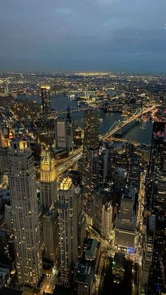 an aerial view of the city lights and skyscrapers in new york city at night