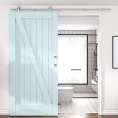 a white bathroom with a blue sliding door