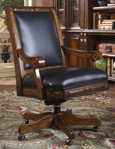 a wooden desk chair sitting on top of a rug