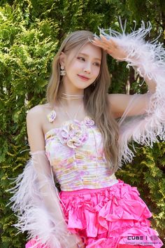 a girl in a pink dress with white feathers