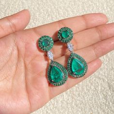 Paraiba Tourmaline Earrings featuring semi precious green stone surrounded with cz diamonds. Ideal to pair with your formals and statement look. These PREMIUM QIUALITY emerald green CZ Earrings are surely elevate your look and give you a LUXURY look. Perfect gift for Her *𝐏𝐑𝐎𝐃𝐔𝐂𝐓 𝐃𝐄𝐓𝐀𝐈𝐋* * 𝐌𝐚𝐭𝐞𝐫𝐢𝐚𝐥: Brass * 𝐏𝐥𝐚𝐭𝐢𝐧𝐠: Black Rhodium Plated * 𝐒𝐭𝐨𝐧𝐞: AAA-quality CZ Diamond & Doublet. *𝐃𝐈𝐌𝐄𝐍𝐒𝐈𝐎𝐍𝐒* * 𝐖𝐞𝐢𝐠𝐡𝐭: 8 gm each * 𝐋𝐞𝐧𝐠𝐭𝐡: 1.7 Inches * 𝐖𝐢𝐝? Green Hand-set Diamond Earrings, Green Hand Set Diamond Earrings, Fine Jewelry Green Diamond Earrings, Cubic Zirconia Gemstone Bridal Earrings For Parties, Green Diamond Drop Earrings, Party Bridal Earrings With Cubic Zirconia Gemstones, Green Diamond Earrings With Diamond Accents, Exquisite Emerald Earrings For Wedding, Exquisite Emerald Wedding Earrings