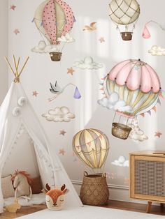 a child's bedroom with hot air balloons and stars on the wall