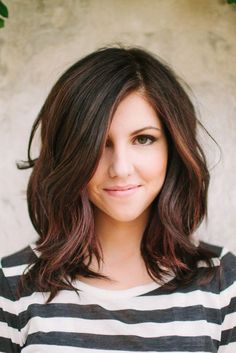 a close up of a person wearing a striped shirt