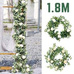 the wedding arch is decorated with white flowers and greenery