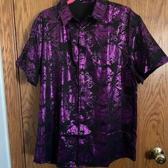 Men's Button Front Shirt By Zeroyaa. Black With Purple Metallic Or Shiny Paisley Print. Short Sleeves. Size Is An Extra Large - Slim Fit. One Extra Button Included. Material Is 95% Polyester. Measurements Lying Flat - 23" Across At Underarms. 19" Shoulder Seam To Shoulder Seam. 9" On The Sleeve Length. 29" From Shoulder Seam To Bottom Hem. Tag Says You Can Machine Wash, Hand Wash May Be Better. Questions Always Welcome. We Ship 6 Days A Week. Smoke Free Home. Thank-You For Your Time & Interest! Purple Outfits Men, Rock Guys, Satin Shirts, Joker Costume, Cross Dress, Metallic Shorts, All Nike Shoes, Paisley Shirt, Purple Metallic