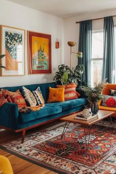 a living room with blue couches and rugs on the floor, windows in the background