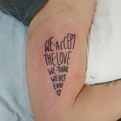 a person with a tattoo on their arm that reads we accept the love we think we don't have