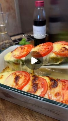 a video demonstrating how to make zucchini boats with tomatoes and cheese in a casserole dish