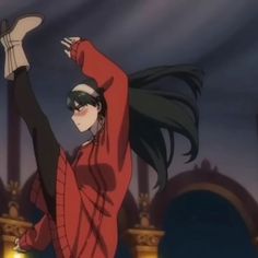 a woman in a red shirt and black pants is dancing with her hands up to the side