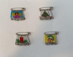 four pieces of beaded hair clips on a white surface with one piece being held in the other