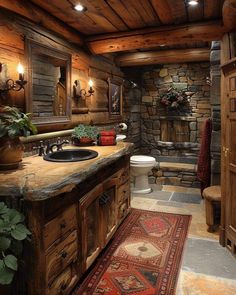 a rustic bathroom with wood paneling and stone walls, along with a rug on the floor