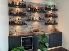 a bar with lots of bottles on the wall and shelves filled with liquor, drinks