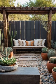 an outdoor seating area with cactus and succulents