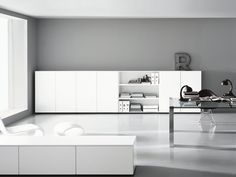 a room with white furniture and gray walls