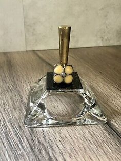 a small glass object on top of a wooden table