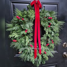 a christmas wreath hanging on the front door