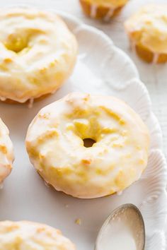 three glazed donuts on a white plate