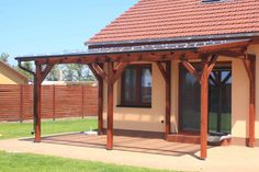 a small house with a covered patio in the yard