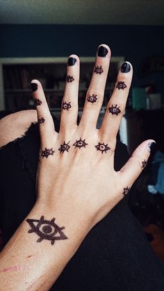 a woman's hand with tattoos on it