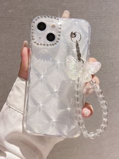 a person holding a cell phone case with a chain attached to the back of it