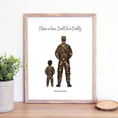 there is a poster with an image of a soldier and a child on it, next to a potted plant