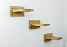 two wooden wall hooks with cat scratching pads on them