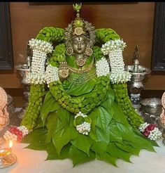 the statue is made out of leaves and flowers