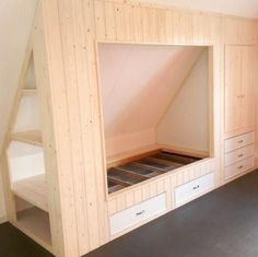 a loft bed built into the side of a wall in a room with white walls