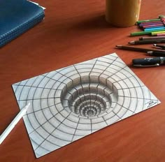 a table with pens, pencils, scissors and other items on top of it