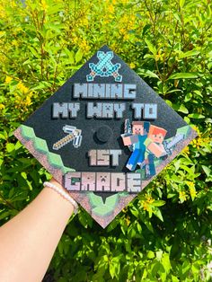 someone is holding up a graduation cap that reads minecraft my way to 1st grade