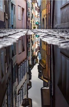 the reflection of buildings in the water is shown