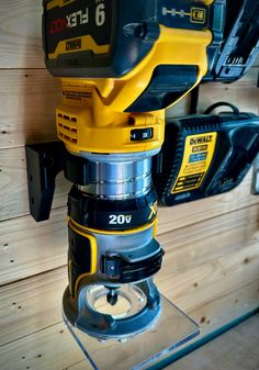 a driller sitting on top of a table next to a wall mounted tool holder