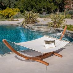 a hammock sitting next to a swimming pool