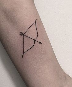 a small bow and arrow tattoo on the arm