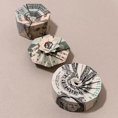 three origami money pieces sitting next to each other