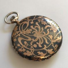 RARE ANTIQUE Silver case with Niello & Rose Gold Patterning Pocket Watch c.1915. Silver cased pocket watch with Niello & rose gold floral patterning to rear of case. Inner cover having the inscription '11 November 1890 - 11 November 1915'. Rare dial having black arabic numerals and minute index set in guilded chapter ring. Guilded subsidiary seconds dial at 6 o'clock and copper and silver vertical stripes to centre of dial. Dial signed 'Tavannes Watch Co'. Blue steel hands. Mechanical Swiss Lever movement. Bow wound & hand set. Case hallmarked 0.900 continental silver. Please note this a most rare watch. Watch dimensions - 47mm diameter. Height inc. bow 61mm. This watch is sold with a 12 month guarantee from Fine Times MBHI certificated watchmakers, established 1947. All watches will be se Victorian Style Chronometer Watch As Gift, Victorian Style Chronometer Watch For Gift, Formal Victorian Style Pocket Watch, Victorian Engraved Watches With Round Dial, Victorian Style Engraved Watch With Round Dial, Victorian Pocket Watch For Formal Occasions, Victorian Engraved Watch With Round Dial, Victorian Pocket Watch With Round Dial For Formal Occasions, Victorian Engraved Watches For Formal Occasions