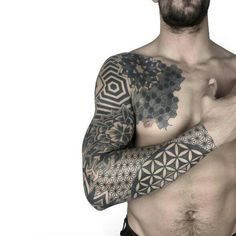 a man with tattoos on his arms and chest