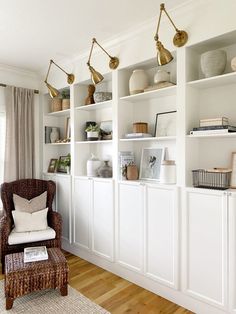 a living room filled with lots of white bookshelves covered in vases and pictures