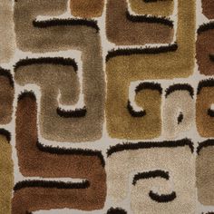 an abstract rug with many different colors and shapes on it's surface, including the letter c