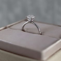 an engagement ring sits in a box