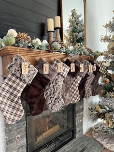 stockings hanging from a mantle in front of a christmas tree