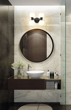 a bathroom with a round mirror above the sink