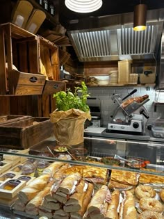 an assortment of breads and pastries on display in a restaurant kitchen with other items