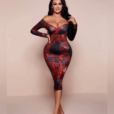 a woman in a red and black snake skin print dress posing with her hands on her hips