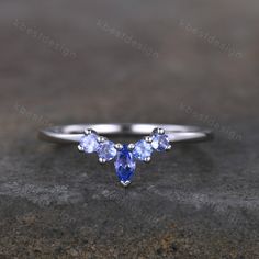 This is a unique curved tanzanite in 925 sterling silver. Stone size: 4X2mm marquise cut + 2mm round cut This ring is marked S925/G10K/G14K I accept custom making order.Please contact me if you need this service. All the jewelry in my store is handmade.It may take 2-3 weeks to finish. I accept custom making order.Please contact me if you need this service. This ring is closed ring.If you want a matching band,you can ask me custom make it. For all the jewelries,there is a 14 days money back guara Tanzanite Engagement Ring Silver, Tanzanite Wedding Band, Engagement Rings Tanzanite, White Opal Engagement Ring, Opal Engagement Ring Set, Opal Wedding Band, Tanzanite Engagement Ring, Opal Wedding Rings, Sterling Silver Rings Set