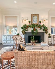 a living room filled with furniture and a fire place in the middle of a room